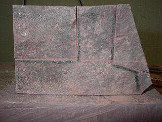 a piece of catlinite with the pipe outline drawn on it