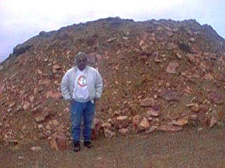 pile of rock and dirt that has been pushed  into place by machinery